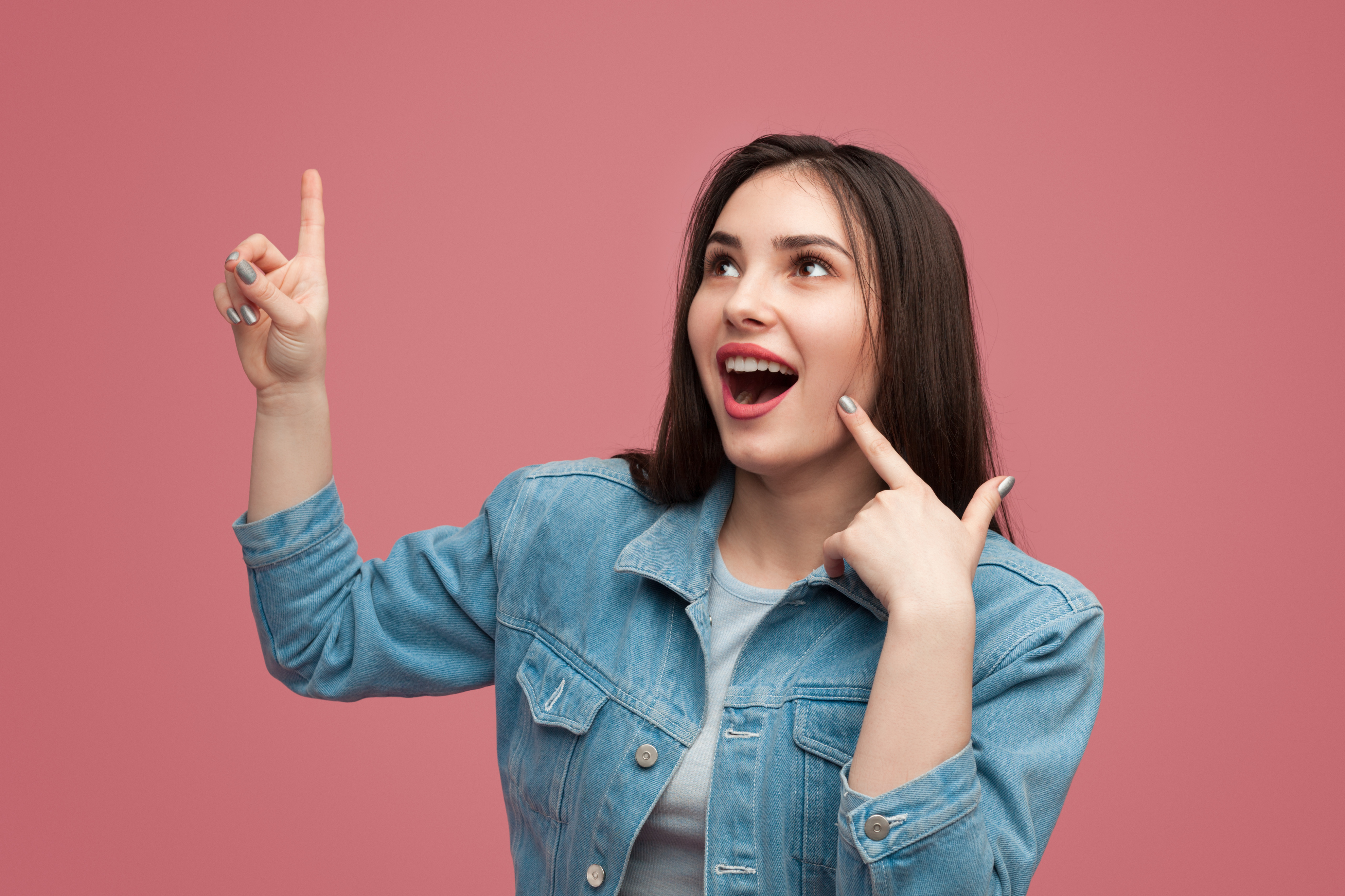 Excited woman pointing up in idea